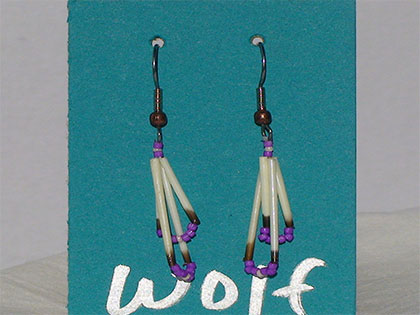 Two short quills and the two long quills all connected with Pearl and Purple size thirteen cut glass beads. Ear attachment is French Hooks